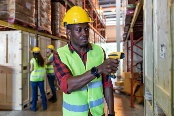 Portrait of African black warehouse worker hold hand scanner to do inventory work stock in distribution warehouse. Traceability FIFO LIFO inventory just in time and warehouse concept photo.