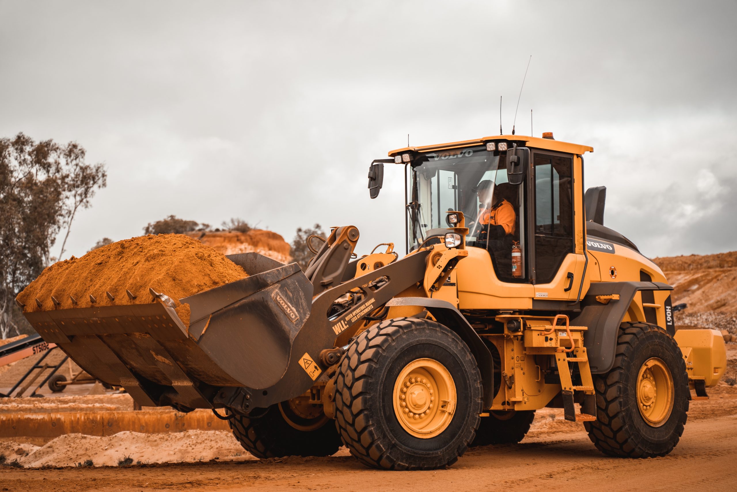 Mining yellow and black heavy equipment on brown field during daytime